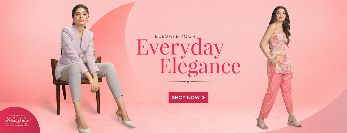 A promotional fashion poster featuring Actress Krithi Shetty modeling coordinated outfits against a pink studio background. One stands in a floral sleeveless top and pink kurti pants, and the other sits in a light lavender blazer and light grey pants.
