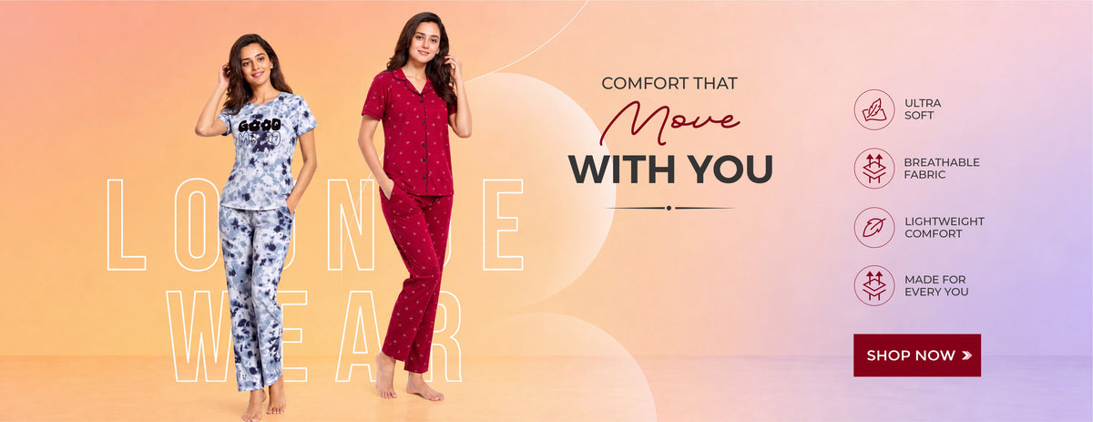 Two women modelling matching pyjama sets against a peach gradient background. One set is light blue and white with a floral print and 'GOOD MOOD' printed on the chest, and the other is dark red with small white polka dots.